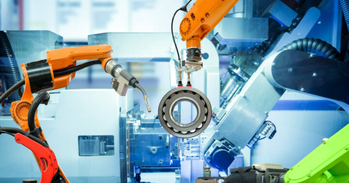 Industrirobotar som håller i ett kugghjul